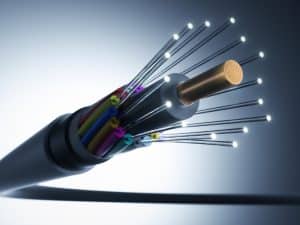 Close-up of fiber optic cable showcasing different colored wires and how signal loss occurs through transmission.